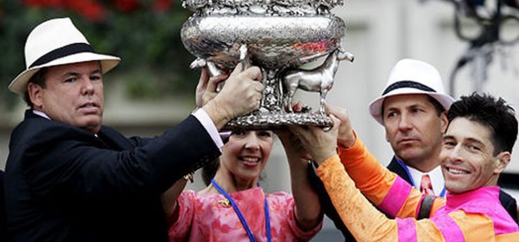 George E. Hall and his team raising the Belmont Stakes trophy